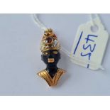 A GOLD AND ENAMELED TRIBAL HEAD PENDANT