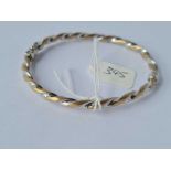 A yellow and white gold 9ct twist hinged bangle 5g