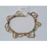 A designer eastern style silver bracelet with coloured enamelled panels and ball pendants marked NR