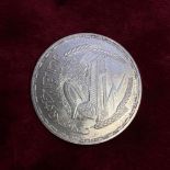 A Eastern silver crown sized coin