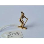 A gold charm in the form of a skier 9ct - 2.9 gms