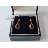 A boxed pair of red stone earrings 9ct - 1.2 gms