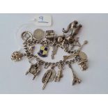 A silver charm bracelet including a large silver cat charm