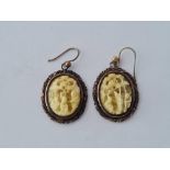 A pair of attractive silver oval oriental carved bone ear pendants