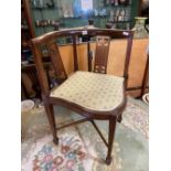 An Art Nouveau corner chair inlaid stretcher base