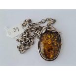 A oval silver and amber pendant necklace