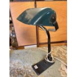 A bankers lamp with green shade