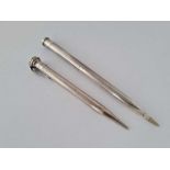 A silver propelling pencil and one other