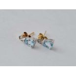 A pair of blue topaz and diamond earrings