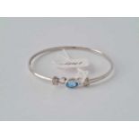 A Topaz and diamond 9ct white gold bangle 4.2g