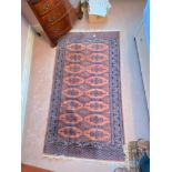 An Oriental Beluche style rug with 2 rows of eight medallions, 36" x 62"