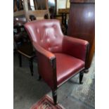 Spoonback library chair on turned mahogany legs with castors