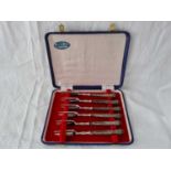 A boxed set of six Queen’s pattern cake forks with silver handles