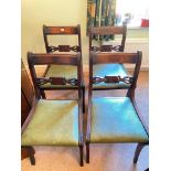 A set f four regency style dining chairs with sabre legs and drop in seats