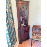 A mahogany reproduction bow fronted corrner cabinet with glazed top, 6ft high