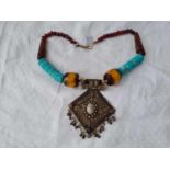 A tribal metal and bead necklace