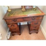 Reproduction Mahogany desk , inset leather top and eight drawers. 36" wide