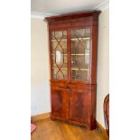 Early 19thC mahogany two part corner cupboard with glazed top. Cupboards below, bracket feet. 86"