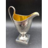 George III Helmet shaped cream jug on square pedestel base. London 1801 By S A 95 gms