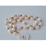 A good vintage pearl necklace with amethyst and 9ct spacer beads and 9ct clasp