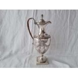 Good George III claret jug of Adam design with drooped festoons and bug finial to cover. 13” high.