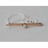 9ct bar brooch set with a centre opal, length 50mm