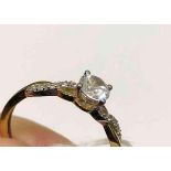 A white gold solitaire ring with stone set shoulders 9ct size O – 1.4 gms