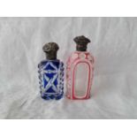 Two Victorian overlay glass scent bottles with silver mounts