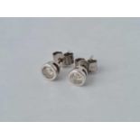 A pair of white gold diamond stud earrings 9ct