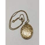 An antique large scroll engraved 9ct locket on 9ct chain 11.4g
