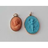 A Victorian gold framed cherub pendant and similar silver framed cherub pendant