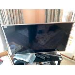 Samsung 30" TV with remotes, paperwork and stand