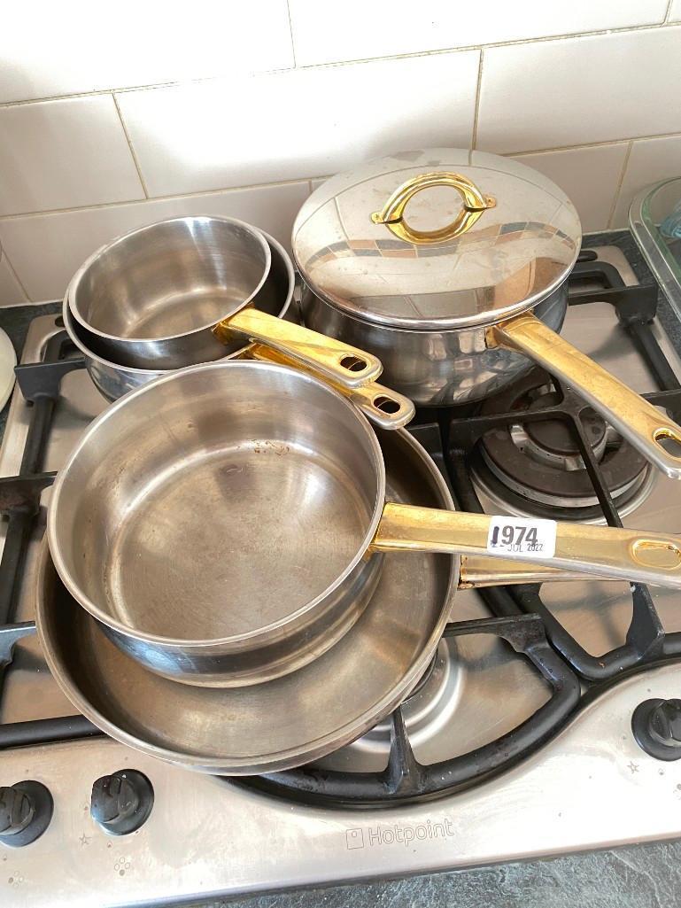 Brass coloured handled saucepans