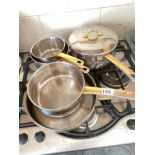 Brass coloured handled saucepans