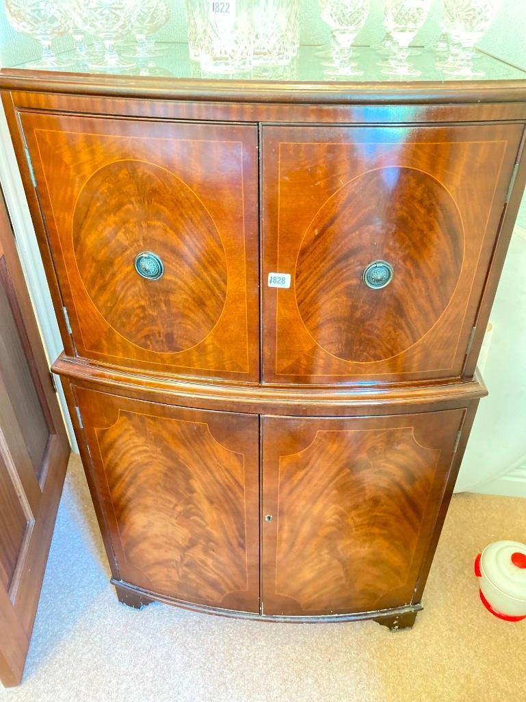 A bow fonted mahogany drinks cabinet with four doors and plate glass top, 29"wide