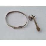 A silver axe brooch and silver bangle