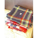 Four various colourful travelling rugs