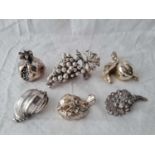 A group of six silver filled items including a bunch of grapes, a shell etc