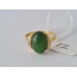 A vintage green stone ring with three diamonds mounted on each side 14ct gold size T – 5 gms