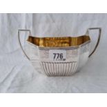 A George III sugar basin with half fluted decoration, gilt interior, 7.5" over handle, London