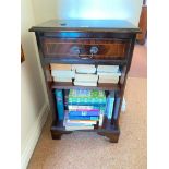 A small cabinet with bookshelves and drawer, 18" wide, with books