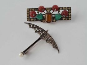 A Edwardian silver and paste umbrella brooch and silver art deco flower brooch