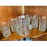Cut glass water jug and six tumblers and a shelf of glass ware