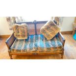 A 1920s Berjere settee with cane back and double cane sides. 53" wide