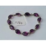 A silver and amethyst bracelet