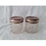 Pair of circular jars with cut glass bodies. London 1913.