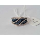 A silver ring set with blue and white diamonds size S