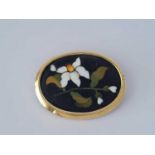 An antique Pietra Dura yellow metal brooch