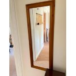 A pine framed mirror with bevelled plate, 18" wide x 48" high