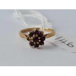 A garnet cluster ring (one stone missing) size M – 1.9 gms